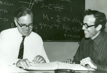 Aage Bohr and Ben Mottelson studying some papers
